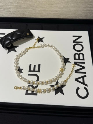 Chanel light gold bracelet with white pearls and full pavé-set stones.