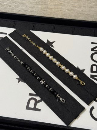 Chanel light gold bracelet with white pearls and full pavé-set stones.