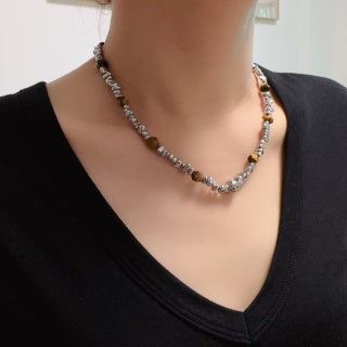 Chunky necklace featuring tiger's eye, silver beads, and crushed silver elements.
