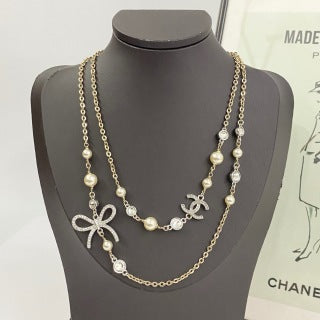 Chanel Elegant Ribbon Pearl Charm Necklace